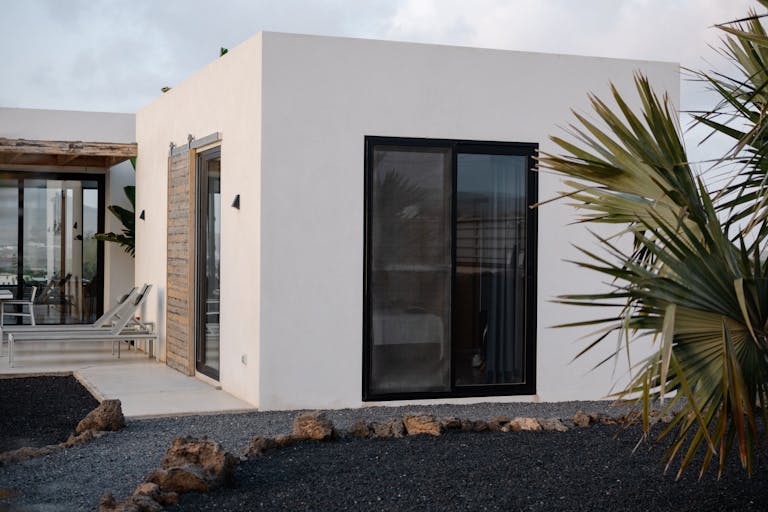A stylish modern villa with minimalist architecture located in the Canary Islands, Spain, featuring natural elements.